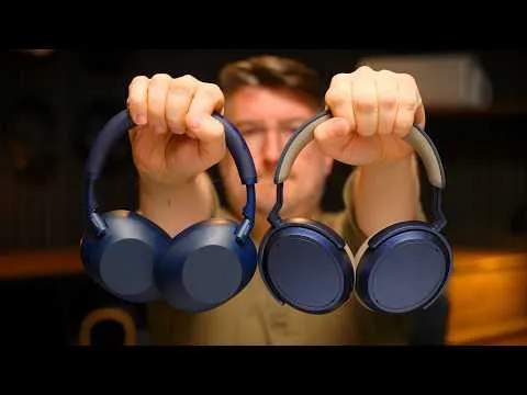 A man holding up the Sennheiser Momentum 4 Wireless Noise Cancelling Headphones to show their overall design and scale.
