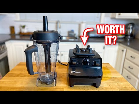 Vitamix 5200 blender base next to its container on a wooden countertop, showing the control dials and motor base.